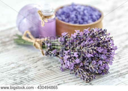 Lavender's Spa Products With Dried Lavender Flowers On A Wooden Table. Flat Lay Bath Salt And Massag