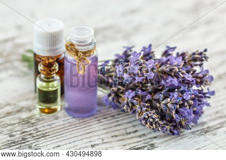 Lavender's Spa Products With Dried Lavender Flowers On A Wooden Table. Flat Lay Bath Salt And Massag