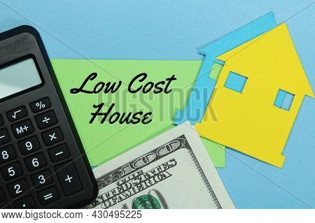 Calculator, Paper Money, Paper House, Colored Paper With The Word Low Cost House
