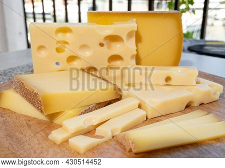Cheese Collection, Hard French Cheeses Comte And Emmentaler With Round Holes Made From Cow Milk