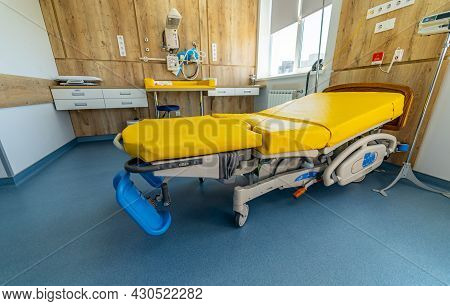 Empty Patient Beds In A Maternity Ward. Modern Light Ward Of Maternity Hospital. Yellow Bed. Stock P