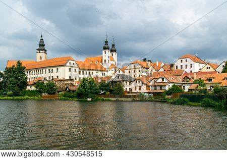 View Of Telc City Panorama With Cloudy Sky Seen From The Surrounding River. The Historic Center Of T