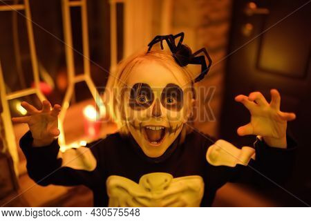 Little Child In Scary Skeleton Costume At Halloween Celebration Party. The Child Is Ready For Trick 