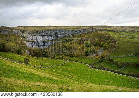 Malham Cove, A Huge Curving Amphitheatre Shaped Cliff Formation Of Limestone Rock In Yorkshire Dales