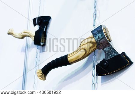 Retro Style Axes On A White Wall. Trade In Medieval Weapons In The Shop. Close-up