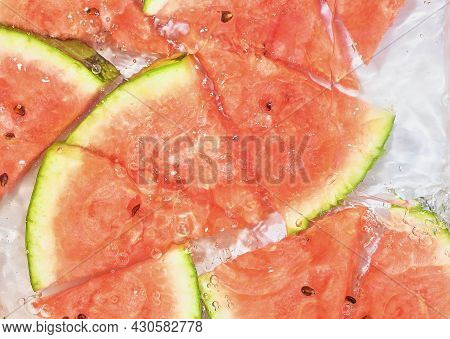 Slices Of Melon In Water On White Background. Melon Close-up In Liquid With Bubbles. Slices Of Red R