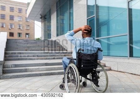 Irritated Impaired Black Man In Wheelchair Having No Possibility To Enter Building Without Ramp, Out