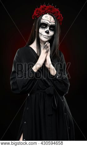 Young Woman With Calavera (sugar Skull) Makeup. The Witch Girl With Muertos (muerte) Greasepaint In 