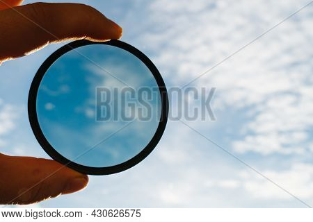 Cpl Polarization Filter For Photo Video Cameras In Mans Hand Against The Background Of The Sky