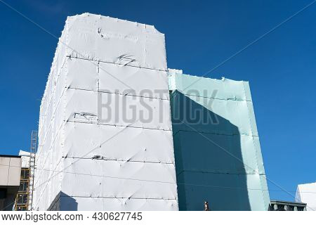 Mufti-story Building In Shrink-wrap To Protect Workers Inside And Public On Outside From Risks Assoc