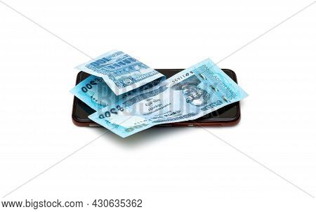 Two Folded One Hundred Taka Bangladesh Banknotes Above A Smartphone On An Isolated White Background