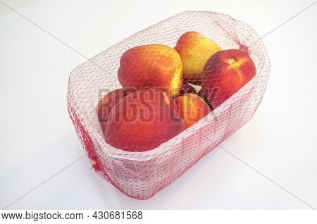 Nectarines On Their Plastic Package Covered. Closeup