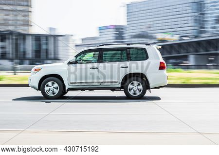 Toyota Land Cruiser 200 Driving On Street In Centre Of City With Sun Light At Background. Moscow, Ru