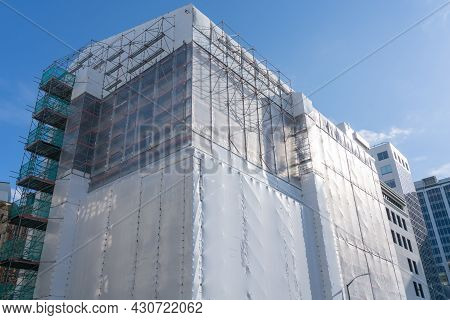 Wellington New Zealand - July 30 2021; Multi-story Building In Shrink-wrap To Protect Workers Inside