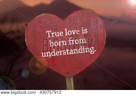 Inspirational Quote - True Love Is Born From Understanding. Text Message On Light Red Sign Board Wit