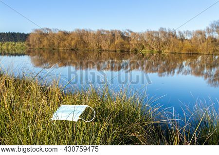 Mask Left On Some Plant Grass By A Clean River.