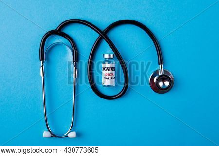 Vaccine bottles covid - 19 delta variant, vials medicine and syringe injection isolated on blue. Coronavirus DELTA 2019-ncov.