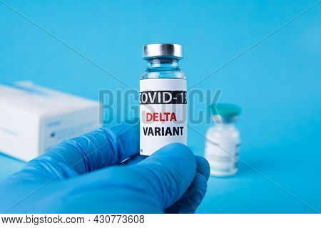 Vaccine bottles covid - 19 delta variant, vials medicine and syringe injection isolated on blue. Coronavirus DELTA 2019-ncov.