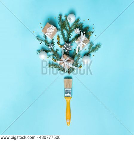 Creative Composition Christmas And New Year. Paint Brush With Christmas Fir And Ornaments On A Red B