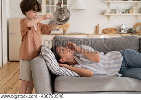 Depressed Young Mother Try To Sleep Suffer From Headache From Noisy Little Son Bang Metal Kitchenwar