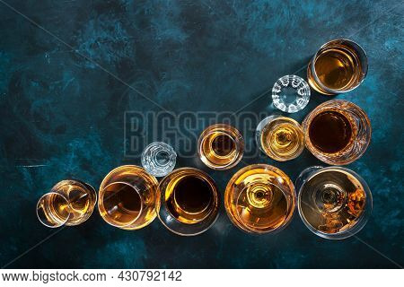 Strong Alcohol Drinks, Hard Liquors, Spirits And Distillates Set In Glasses: Cognac, Scotch, Whiskey