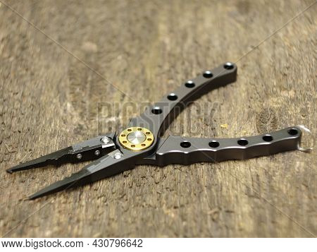 Pliers With Sharp Nippers And Narrow Jaws On Wooden Background Close-up