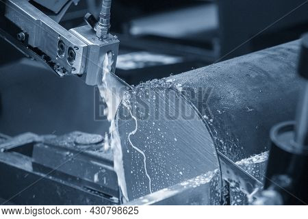 The Automatic Band Saw Machine Cutting The Metal Bar With Water Base Coolant Method. The Machine Too