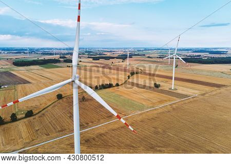 Windmill Among Agricultural Fields. Wind Turbine Generator At Summer Day. Wind Energy Concept, Suist