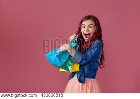 Little Caucasian Child Girl Holds Shopping Bags