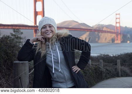 View Of A Young Girl In Black Coat Near Golden Gate In San Francisco