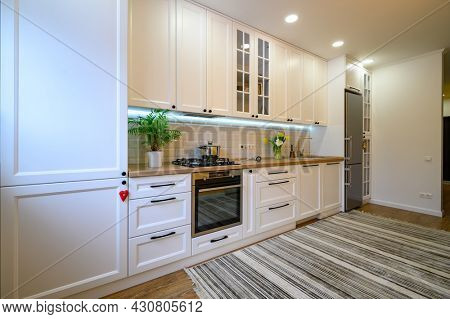 cozy well designed modern kitchen interior with appliances and dining table