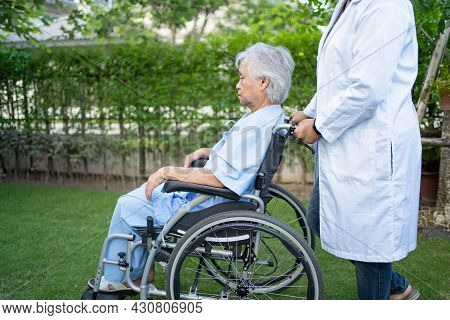 Doctor Help And Care Asian Senior Or Elderly Old Lady Woman Patient Sitting On Wheelchair At Park In