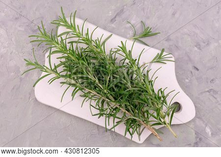 Sprigs Of Rosemary On A Wooden Board. Flat Lei.