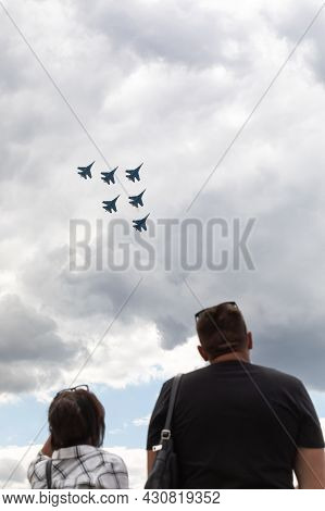 25.07.2021, Russia, Zhukovsky. Spectators Look Into The Sky Behind Military Aircraft Fighters Perfor