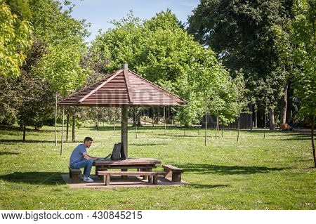 Pancevo, Serbia - May 22, 2021: Man, Online Male Worker, Digital Nomad, Freelancer, Working Outsidea