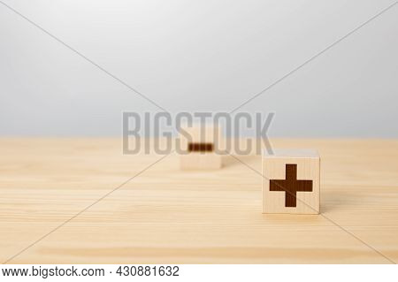 Pros And Cons Concept. Choosing Plus With Blurred Minus Symbol. Concept Of Opposites, Wood Block Wit