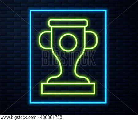 Glowing Neon Line Award Cup Icon Isolated On Brick Wall Background. Winner Trophy Symbol. Championsh