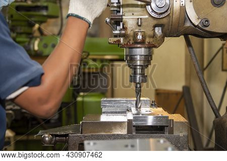 The Machine Operator Drilling The Hole On Metal Plate With Nc Milling Machine. The Shop Floor Operat