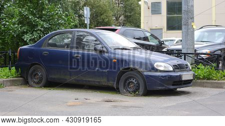 Old Rusty Dark Blue Car With Flat Wheels, Ulitsa Antonova-ovseenko, St. Petersburg, Russia, August 2