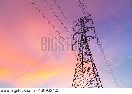 Horizontal Silhouette Of Electric Pole With Purple Blue Sky In The Evening.