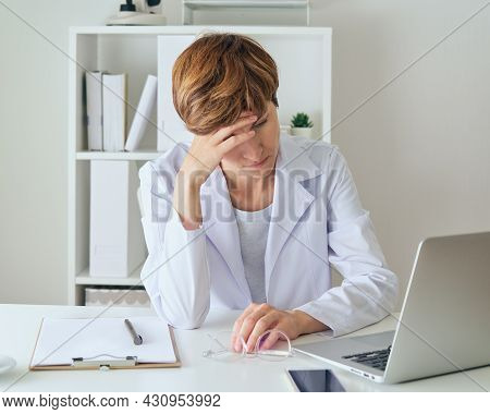 Woman Doctor Suffering From Professional Burnout. Exhausted And Workload Healthcare Worker Having He
