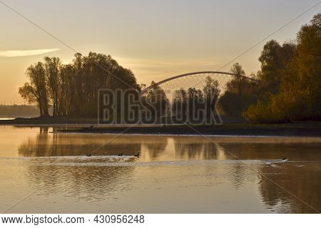 Golden Dawn On The River Bank. Golden Cream Dawn, Haze Over The Calm Water Of The River, The Reflect