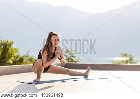 Fit Yoga Woman Doing Skandasana Pose Outdoors In The Morning