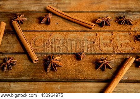 CINNAMON STICKS ON WOODEN BACKGROUND
