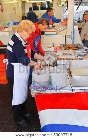 Workers Cut Up Fish For Sale At A Market In Dordrecht, Netherlands