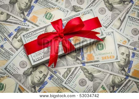 Stack of Newly Designed U.S. One Hundred Dollar Bills Gift Wrapped in Red Bow.