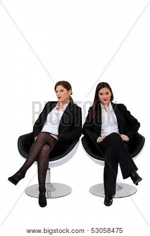 Businesswomen sitting side by side