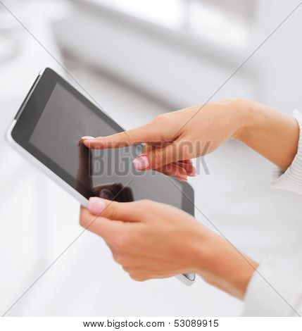 office, business, technology and internet concept - businesswoman with tablet pc in office