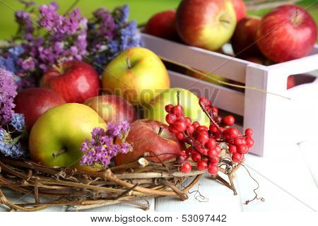 Juicy apples in box on white wooden table