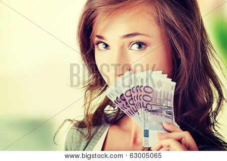 Happy young woman holding money